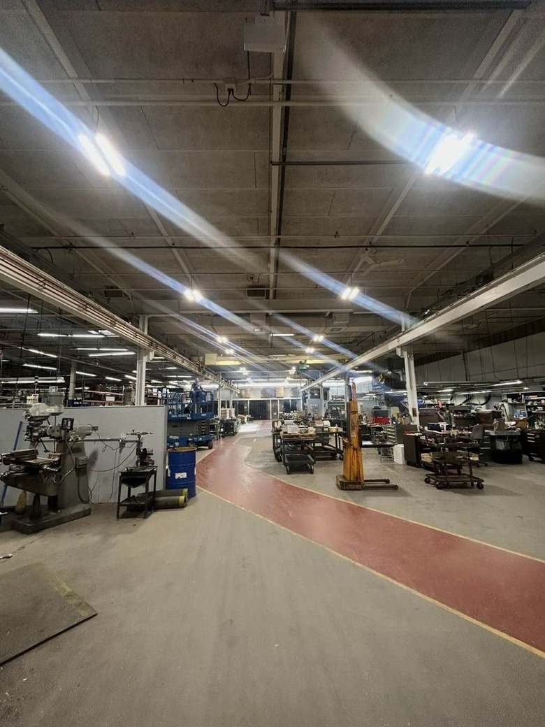 Overhead lighting across a manufacturing floor